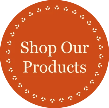 Orange circular sticker with 'Shop Our Products' text, featuring decorative leaf border design.